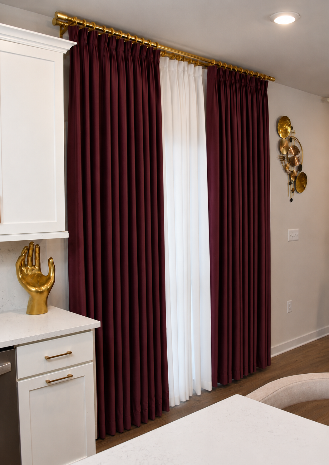 Burgundy pinch pleat curtains with gold hardware